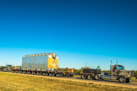 A hydraulic platform trailer transports large, heavy loads