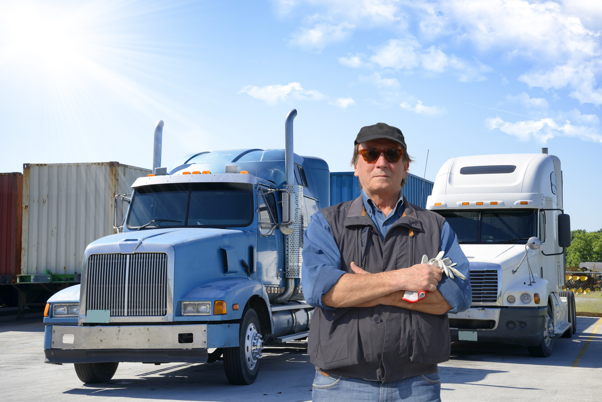 Parish Transport team member in front of fleet of trucks